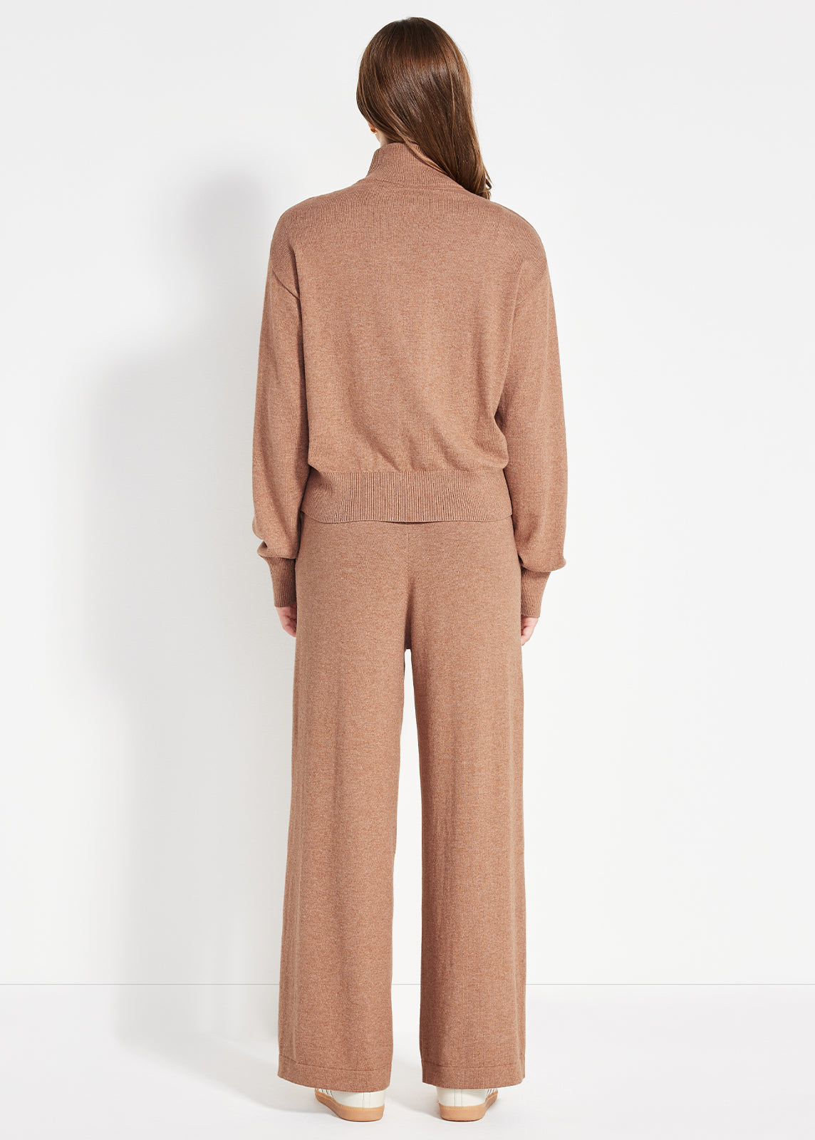Back view of camel knit lounge set with ribbed hem and relaxed fit