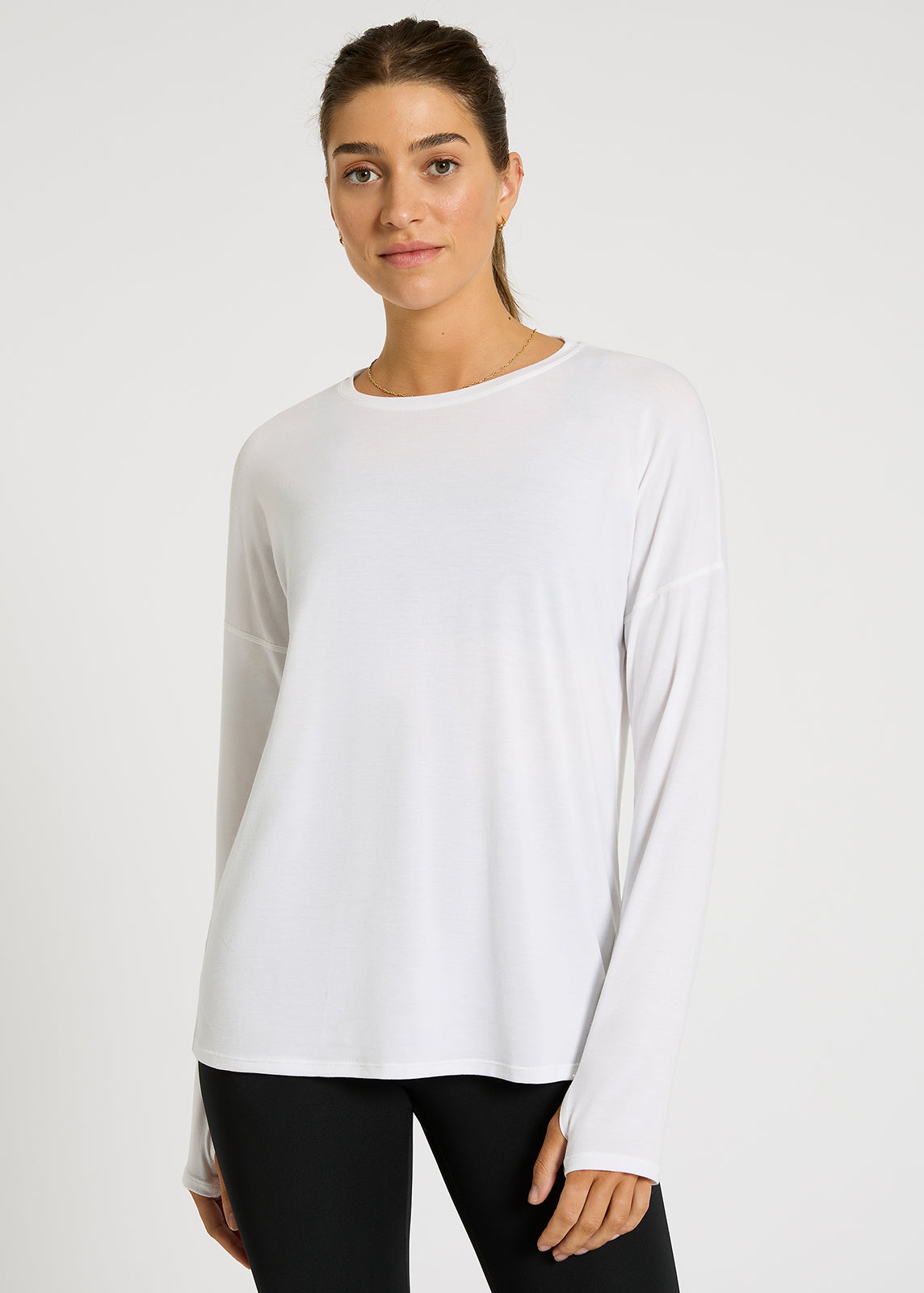 Model wearing long-sleeve white top