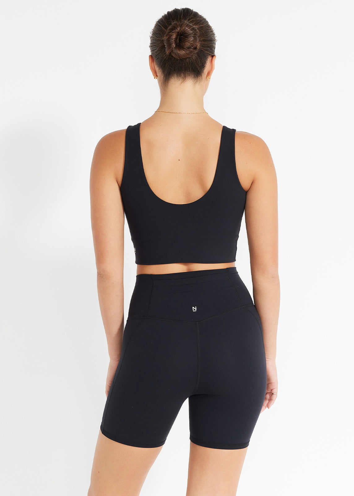 Back view of black scoop crop and high-rise bike shorts designed for ease and movement