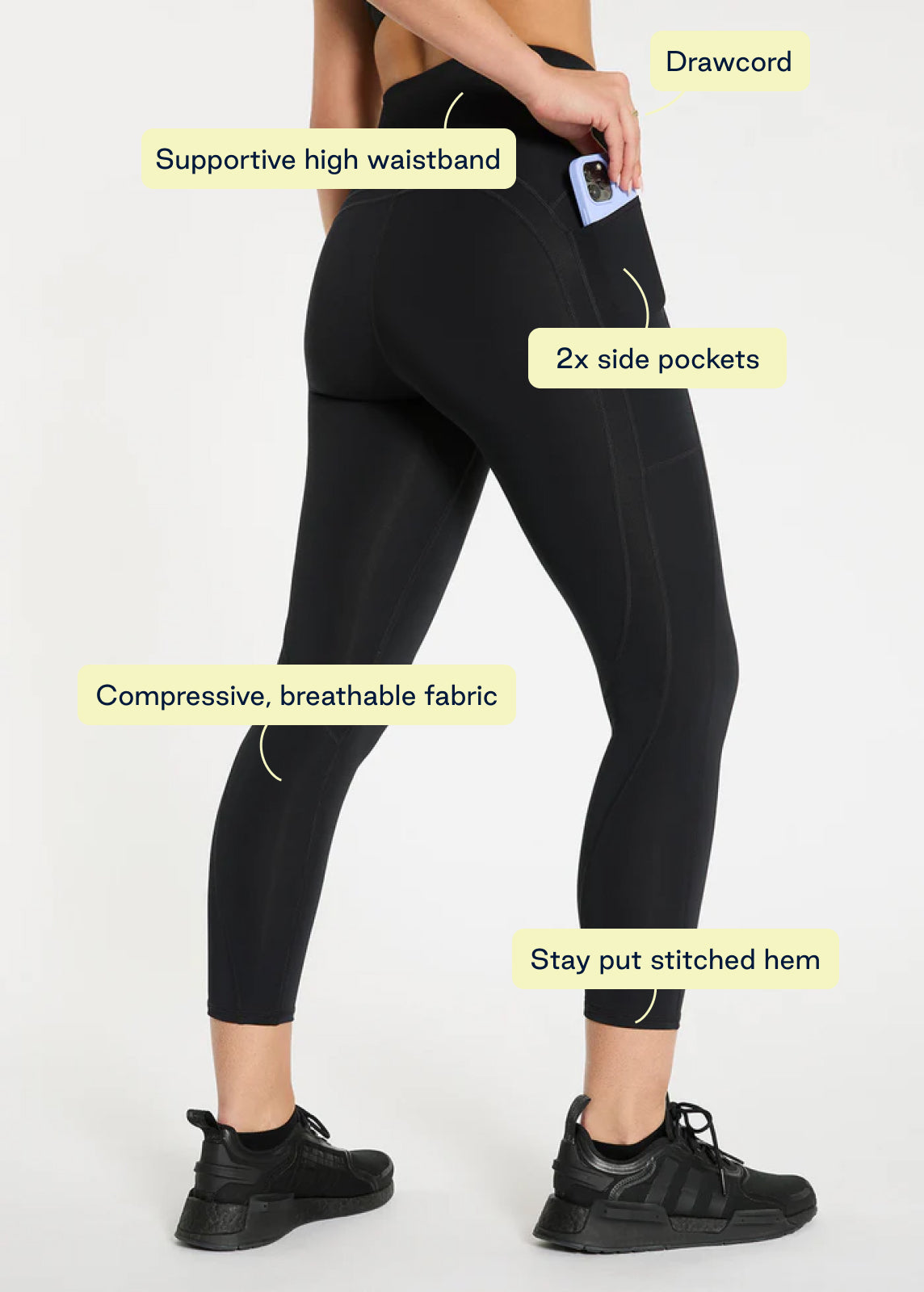 Model wearing navy leggings and black long sleeve top for cool-weather workouts